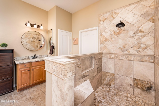 bathroom featuring vanity and tiled shower