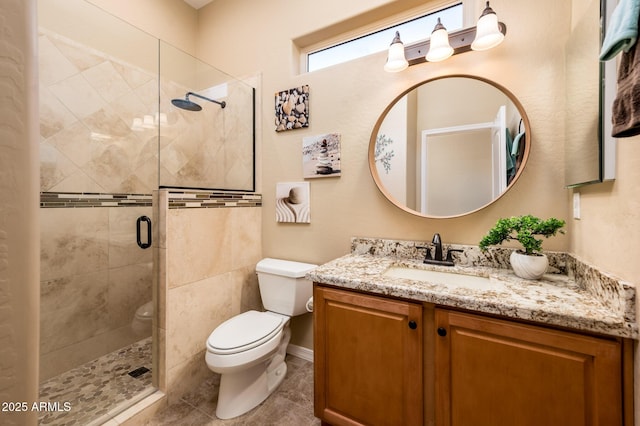 bathroom with a shower with door, vanity, and toilet