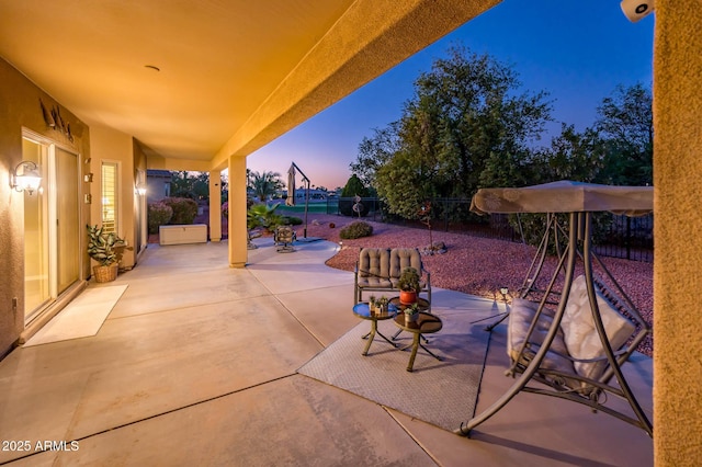 view of patio terrace at dusk