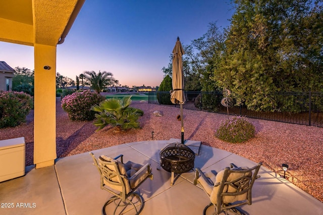 patio terrace at dusk with a fire pit