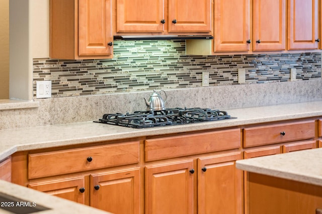 kitchen featuring black gas stovetop and backsplash