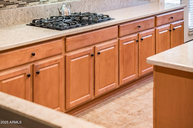 kitchen featuring decorative backsplash and black gas stovetop