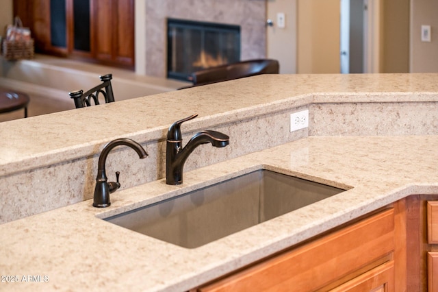 kitchen featuring light stone countertops and sink