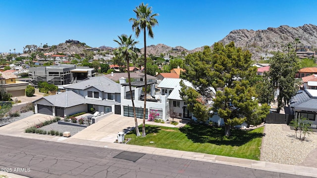 aerial view of residential area featuring a mountainous background