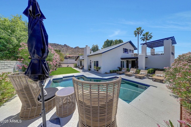 view of pool with a patio area and fence