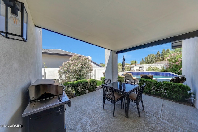 view of patio / terrace with grilling area, outdoor dining space, and a fenced backyard