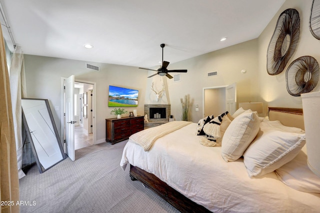 carpeted bedroom featuring a ceiling fan, recessed lighting, baseboards, and a fireplace with raised hearth