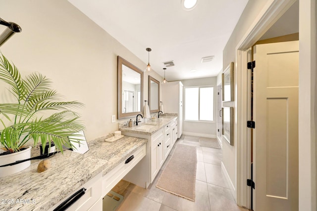 bathroom with tile patterned flooring, double vanity, a shower, baseboards, and recessed lighting