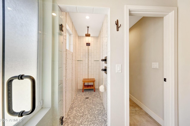 full bathroom with a stall shower and tile patterned floors