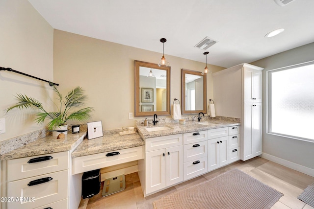 full bathroom with double vanity, tile patterned flooring, and baseboards