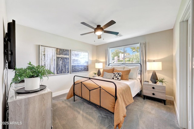 carpeted bedroom featuring baseboards and a ceiling fan
