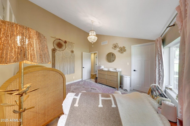 bedroom featuring vaulted ceiling, a chandelier, baseboards, and carpet flooring