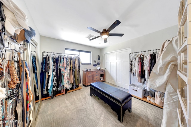 walk in closet with ceiling fan and carpet flooring