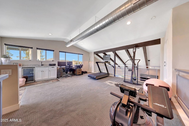 gym with beverage cooler, vaulted ceiling, and light carpet
