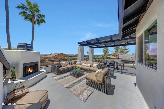 view of patio / terrace with an outdoor living space with a fireplace and a pergola