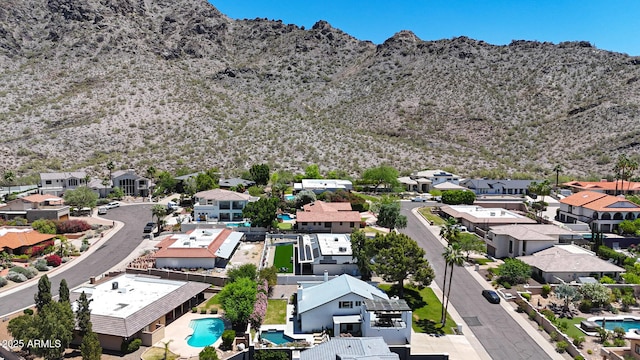 aerial view of residential area featuring a pool area and a mountain backdrop