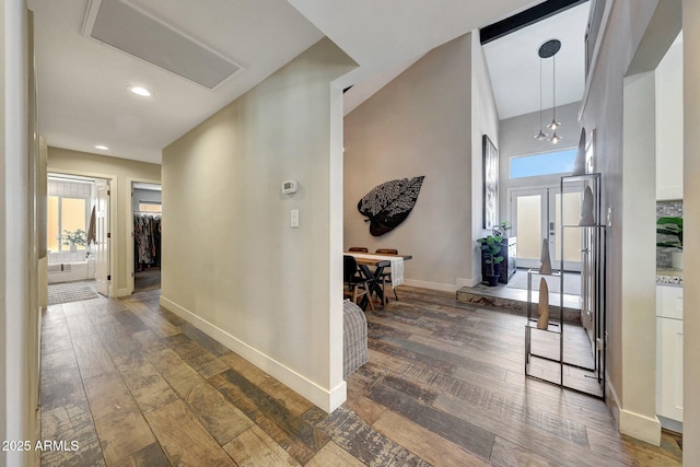hall featuring hardwood / wood-style floors, baseboards, plenty of natural light, and recessed lighting