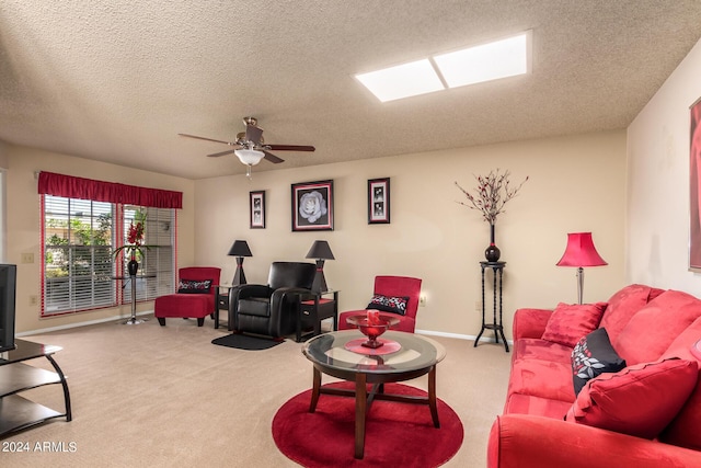 carpeted living area with a textured ceiling, ceiling fan, and baseboards