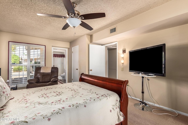 carpeted bedroom with a textured ceiling, ceiling fan, baseboards, and visible vents