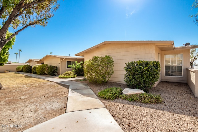 single story home featuring fence