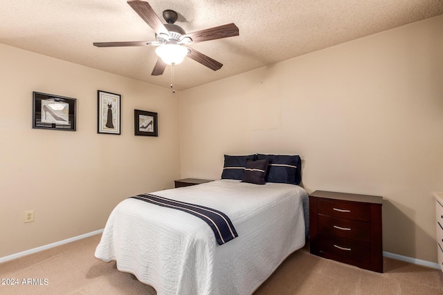 bedroom featuring baseboards, ceiling fan, and light carpet
