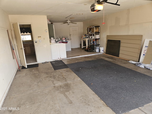 garage with baseboards, ceiling fan, separate washer and dryer, and a garage door opener