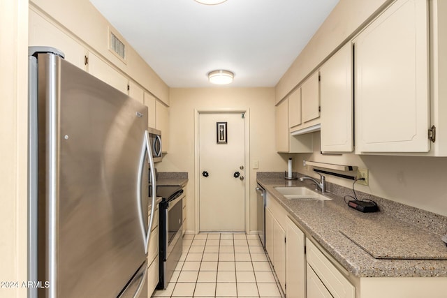 kitchen with light tile patterned floors, visible vents, appliances with stainless steel finishes, light countertops, and a sink