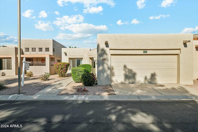 southwest-style home with a garage