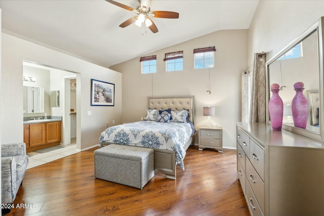 bedroom featuring lofted ceiling, light wood-type flooring, and multiple windows