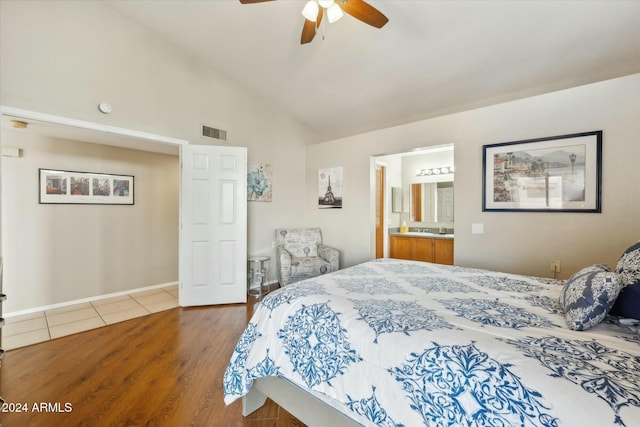 bedroom featuring ensuite bathroom, ceiling fan, high vaulted ceiling, and hardwood / wood-style flooring