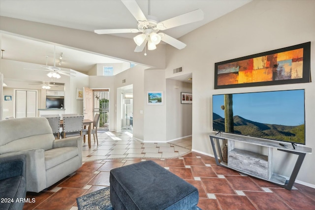 tiled living room with high vaulted ceiling and ceiling fan