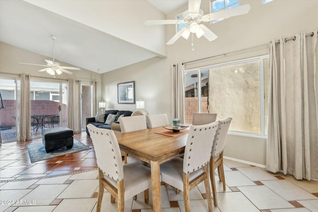 tiled dining room with ceiling fan, a fireplace, and vaulted ceiling