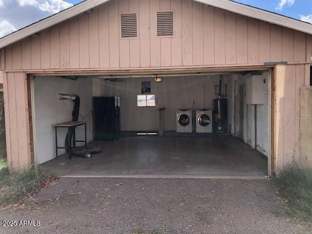 detached garage featuring washer and dryer and water heater