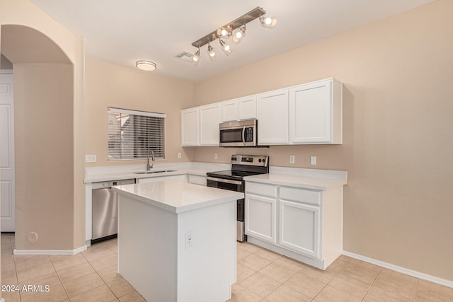 kitchen with white cabinetry, a center island, appliances with stainless steel finishes, and sink