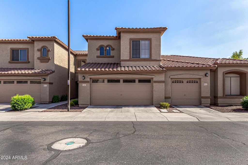 mediterranean / spanish-style house with a garage