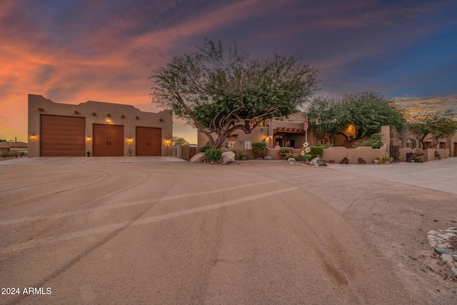 pueblo-style house featuring a garage