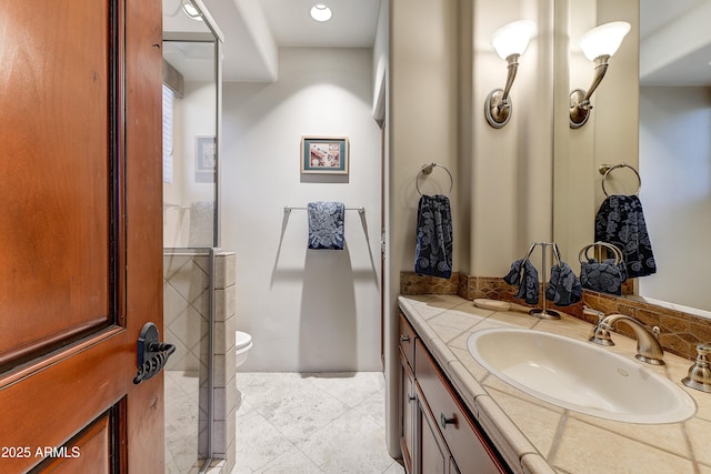 bathroom featuring tile patterned flooring, vanity, and toilet