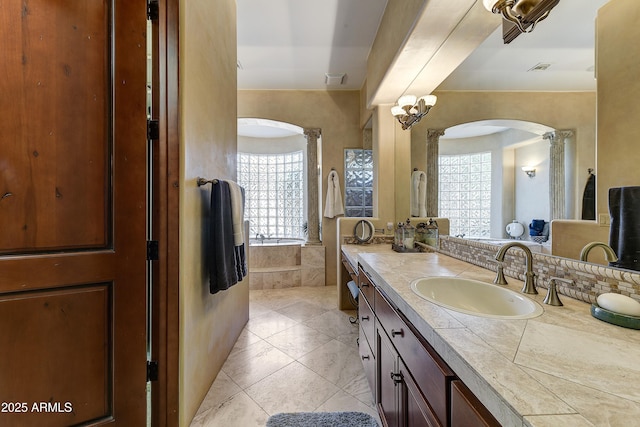 bathroom featuring tile patterned floors, a bathtub, and vanity