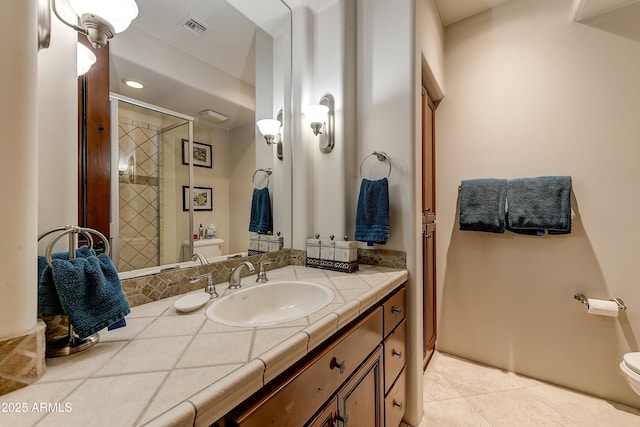 bathroom with tile patterned flooring, toilet, visible vents, vanity, and a stall shower