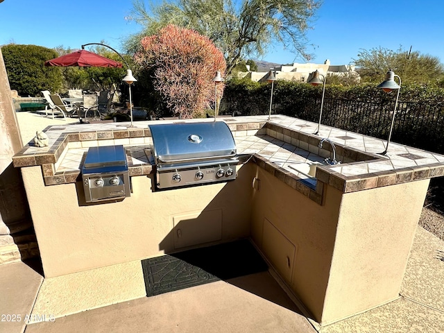 entry to storm shelter featuring a patio area and fence