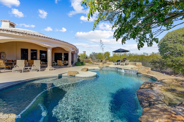 pool with a patio area and fence