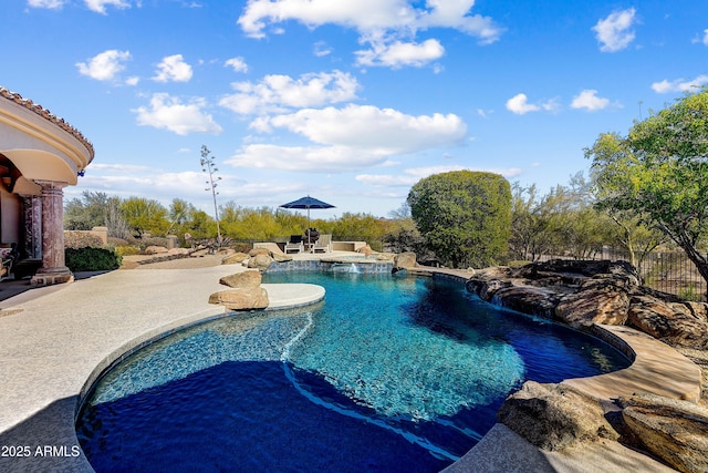 view of swimming pool with a patio area, fence, and a fenced in pool