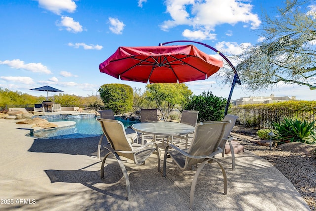 view of patio / terrace with a fenced in pool, outdoor dining space, and fence