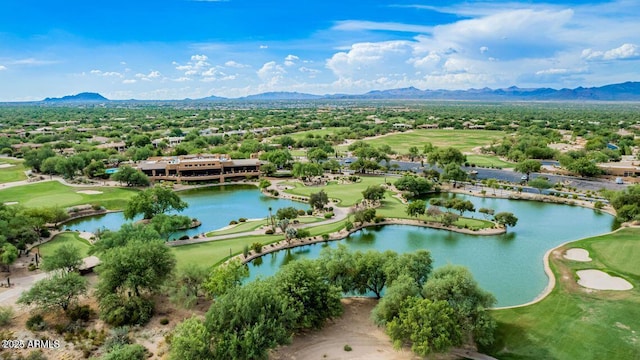 drone / aerial view with golf course view and a water and mountain view