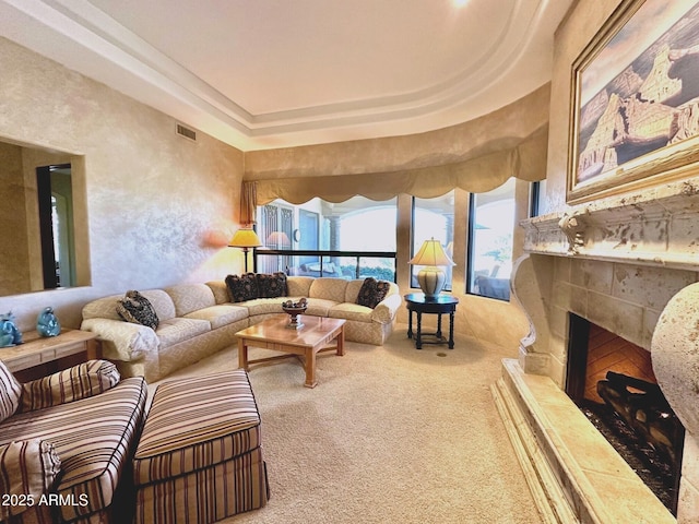 carpeted living area featuring a fireplace and visible vents