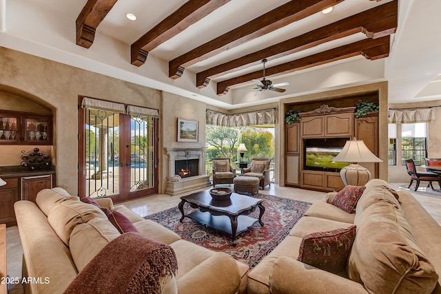 living area featuring french doors, a premium fireplace, and plenty of natural light