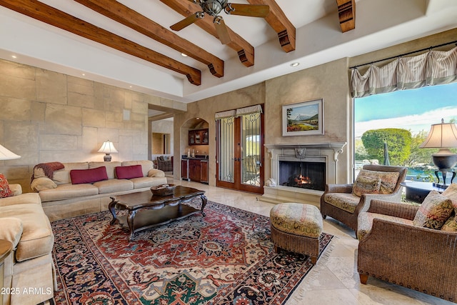 living area with a ceiling fan, recessed lighting, a fireplace, and beamed ceiling