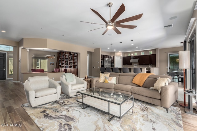 living room featuring ceiling fan and wood-type flooring