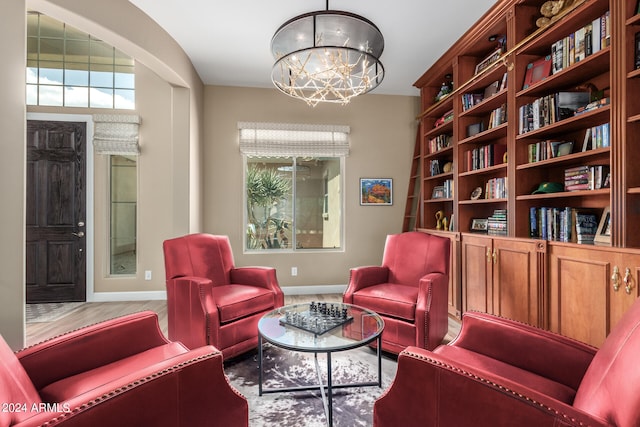 living area featuring a notable chandelier and hardwood / wood-style flooring