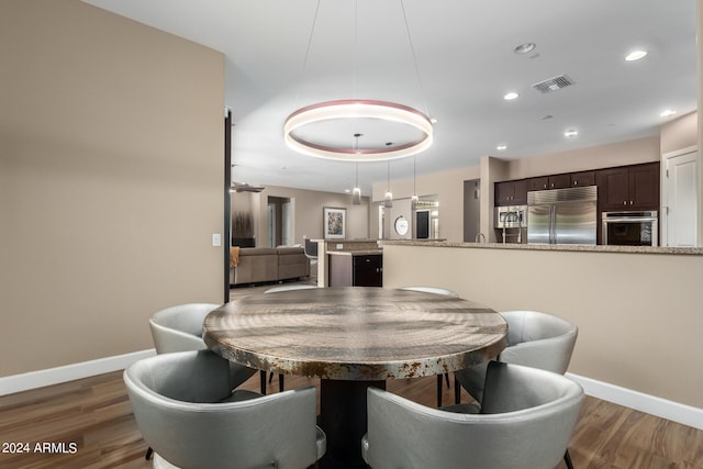 dining space with dark hardwood / wood-style floors